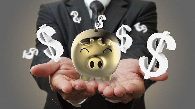 Businessman shows a piggy bank